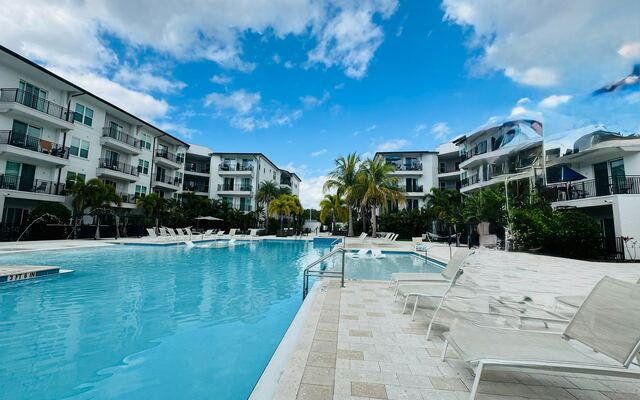 Apartment community with a resort-style pool at dusk