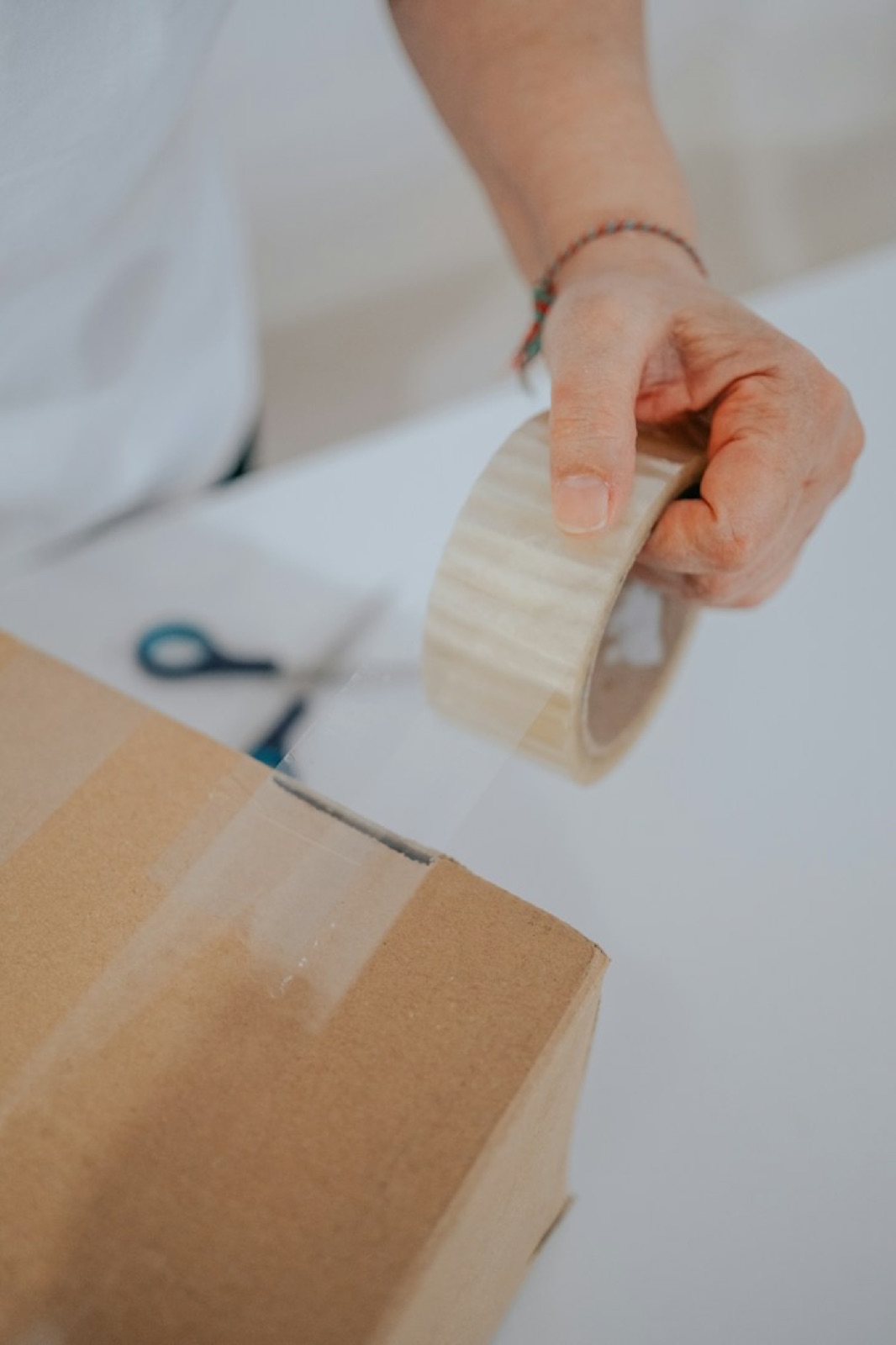 Packing tape being pulled across a box