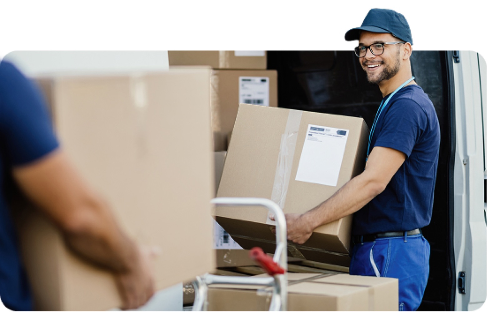 Smiling Ameritex mover unloading boxes from a moving truck