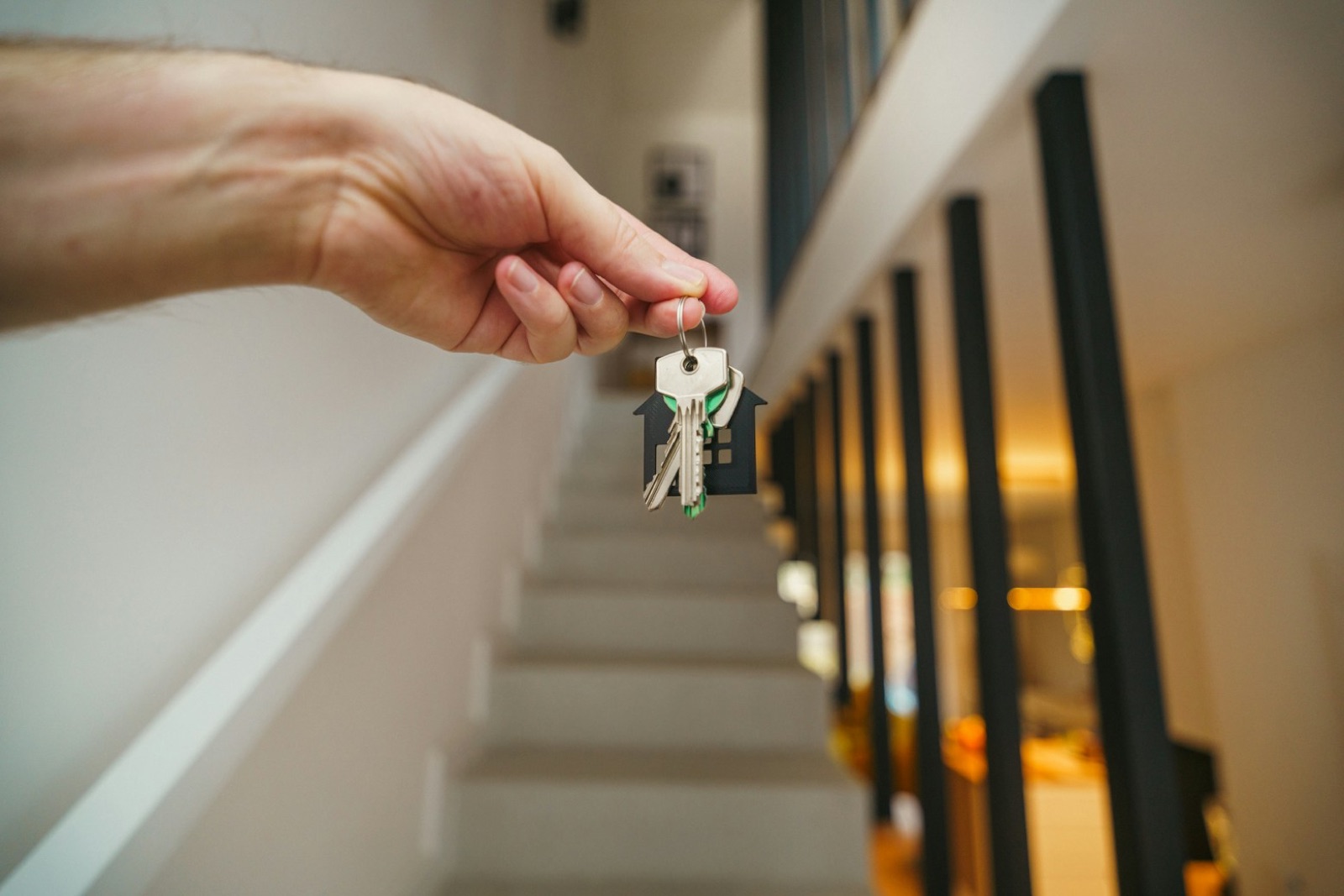 New homeowner holding up the keys to their home