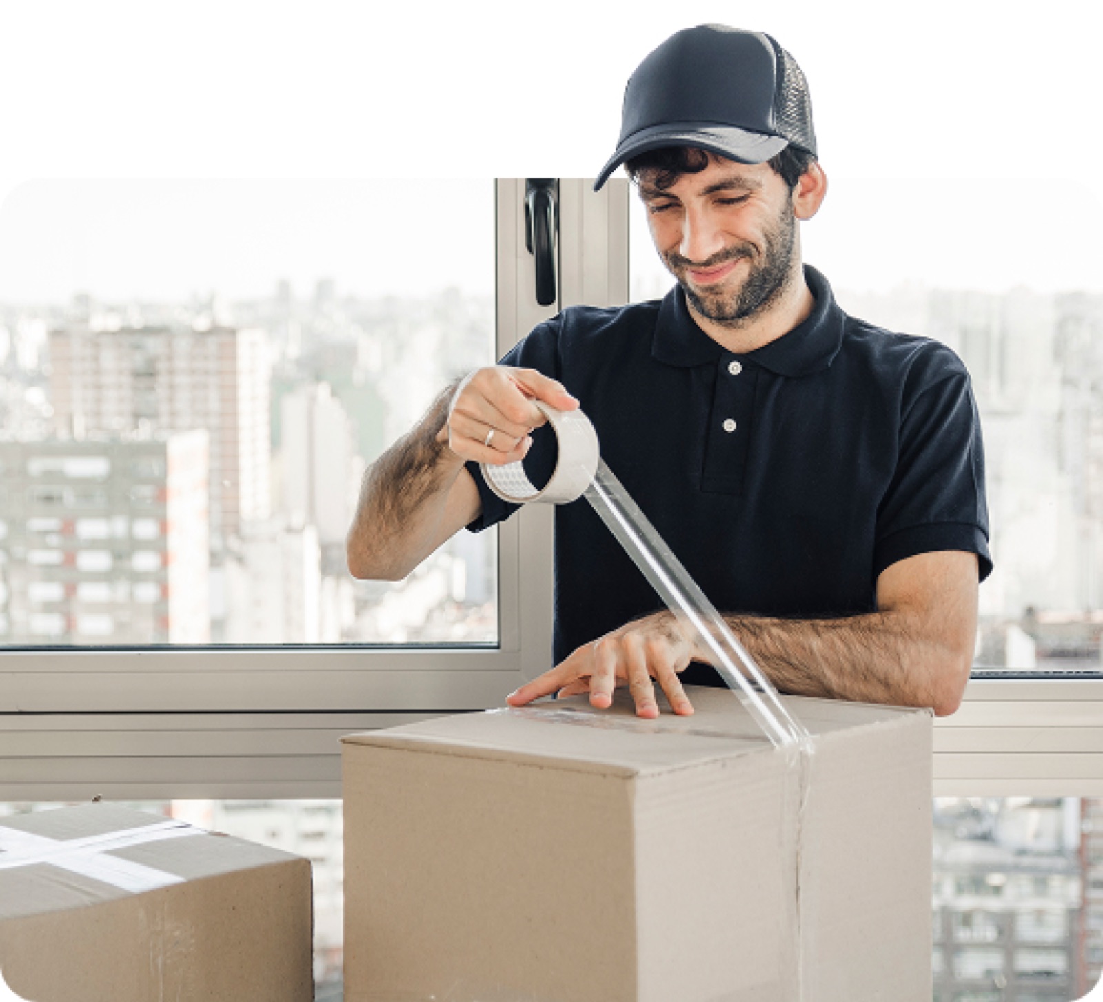 Mover taping up a packed moving box